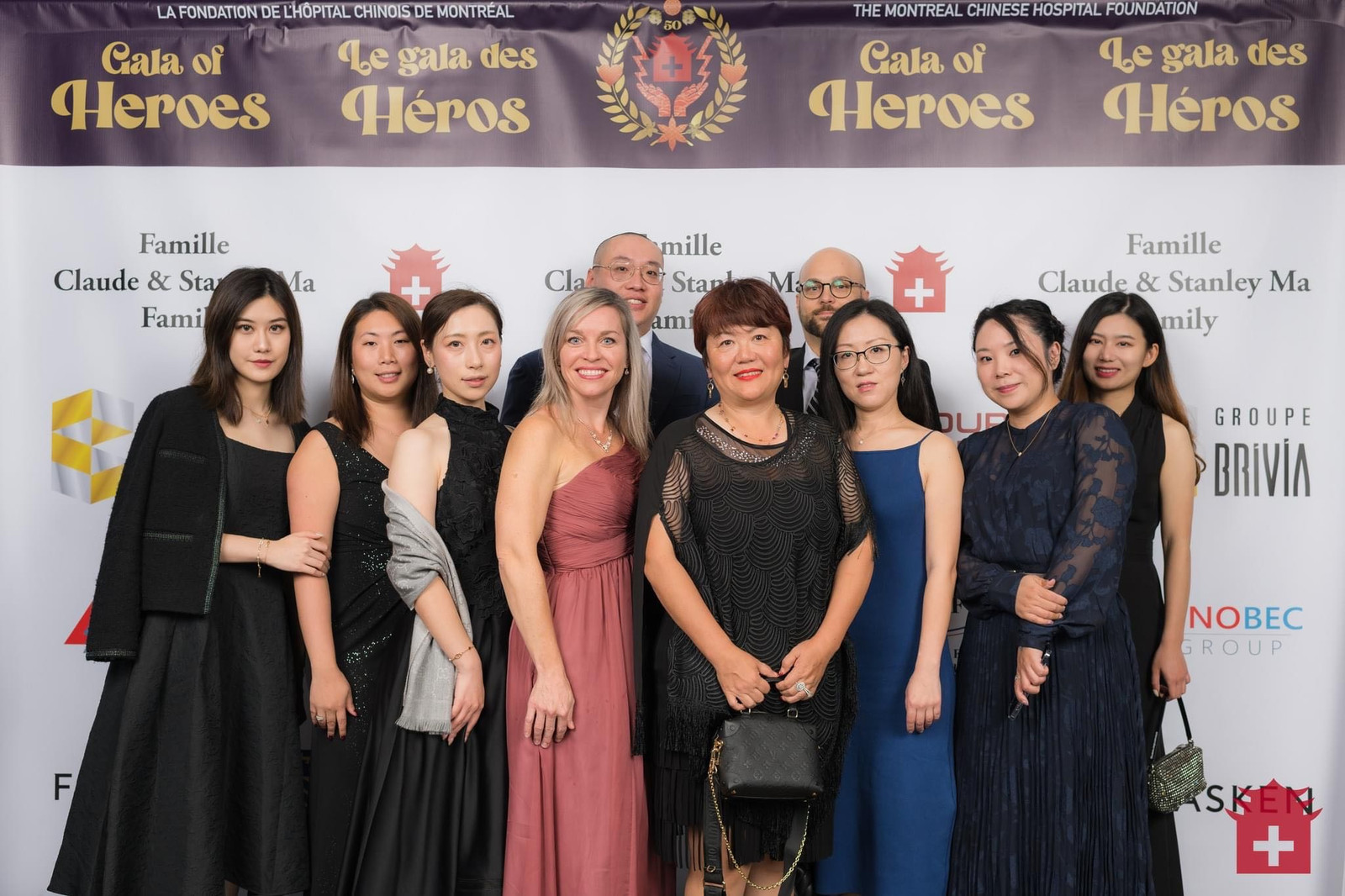 Guests at the 2022 “Gala of Heroes” in front of the sponsor wall