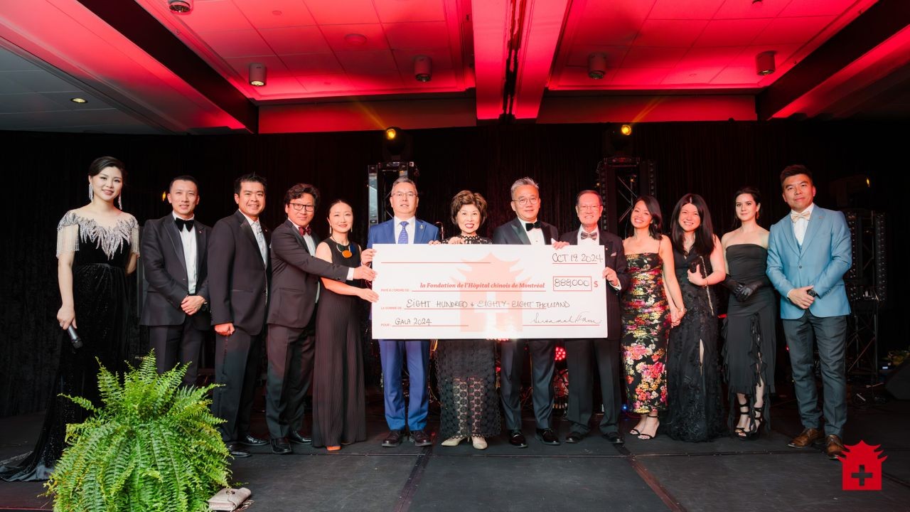 Gala organizers and guests presenting the $888,000 cheque on stage at the 2024 Annual Gala